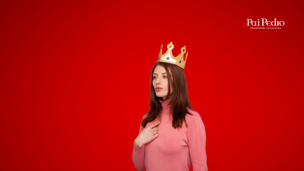 Imagem de uma mulher jovem de expressão confiante usando uma coroa dourada, sobre um fundo vermelho intenso. Ela veste uma blusa rosa e mantém postura ereta, com uma das mãos sobre o peito — gesto que simboliza autovalorização, respeito próprio e poder pessoal. No canto superior direito, aparece o logotipo “Pai Pedro – Quimbanda Luciferiana”, reforçando o tom espiritual e empoderador da imagem.